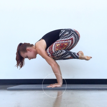 This image shows crow pose with hasta bandha engaged. Notice how all of my knuckles are pressing into the mat. Using hasta bandha will prevent wrist pain and lead to stronger arm balances and inversions.
